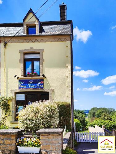 a house with a window and a flower box at Gaume Sweet Home in Moyen