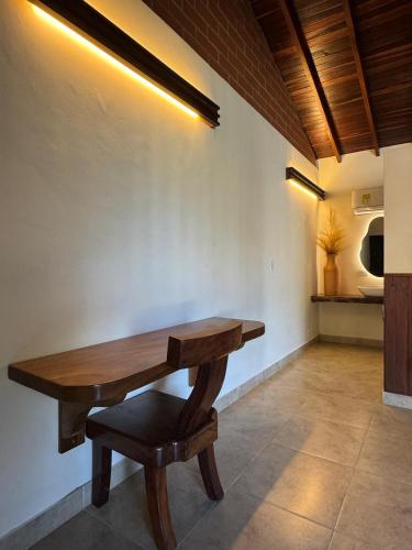 a wooden table and a chair in a room at Casa Fuego in La Pintada