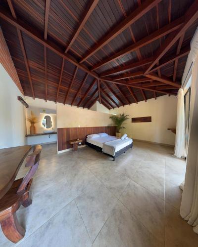 a large bedroom with a bed and a wooden ceiling at Casa Fuego in La Pintada