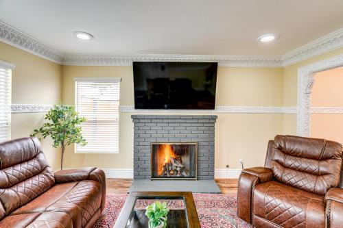 a living room with a fireplace and a tv at Del Rey Oaks Vacation Home with Mini-Golf Course! in Del Rey Oaks