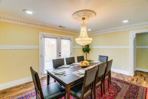 a dining room with a table and chairs and a chandelier at Del Rey Oaks Vacation Home with Mini-Golf Course! in Del Rey Oaks