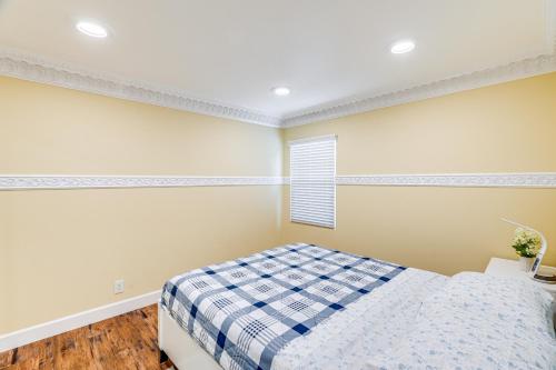 a bedroom with a bed and a window at Del Rey Oaks Vacation Home with Mini-Golf Course! in Del Rey Oaks