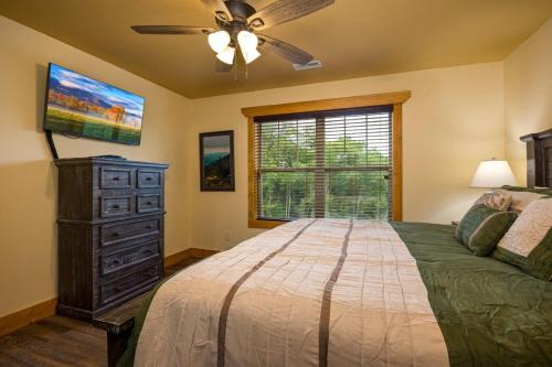 a bedroom with a bed and a ceiling fan at Mountain Palace by Eden Crest in Gatlinburg