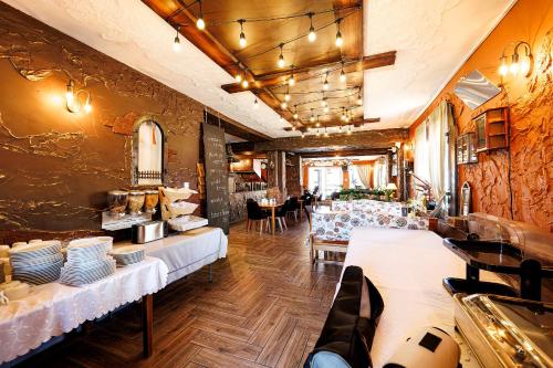 a restaurant with tables and chairs in a room at Stratos in Łeba