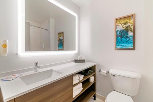 a white bathroom with a sink and a mirror at Comfort Inn & Suites Saratoga Springs in Saratoga Springs