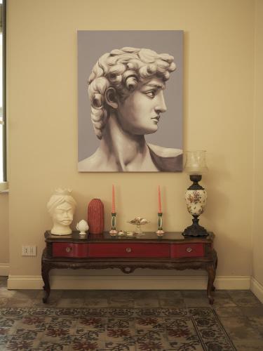 a statue of a bust on a table with candles at Cifilì House of Charme in Catania