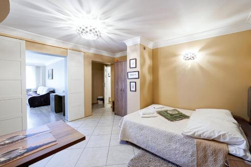 a bedroom with a bed and a living room at Stratos in Łeba
