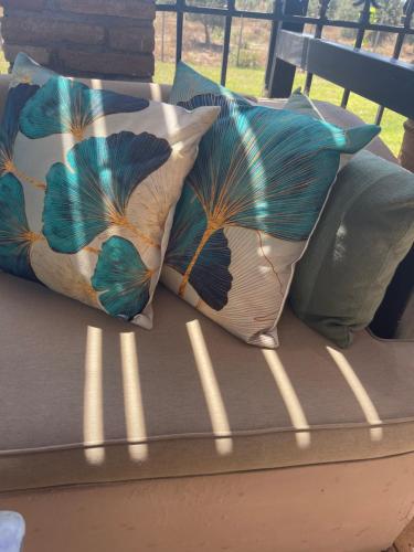 two pillows sitting on top of a bench at Mama’s Sunshine Garden Villa in Áyios Ilías