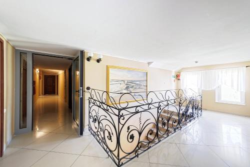 a staircase in a house with a wrought iron railing at Stratos in Łeba