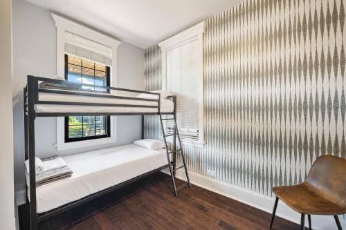 a bedroom with a bunk bed and a chair at Wrigleyville Suites in Chicago