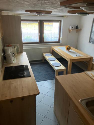 a kitchen with wooden counters and tables and windows at Ferienhaus-Cerny in Bad Goisern
