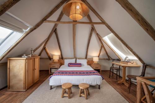 a bedroom with a bed in a attic at Hacienda El Porvenir by Tierra del Volcan in Machachi