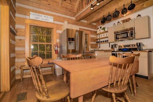 a kitchen with a large wooden table and chairs at Rockin R Lodge by Eden Crest in Sevierville