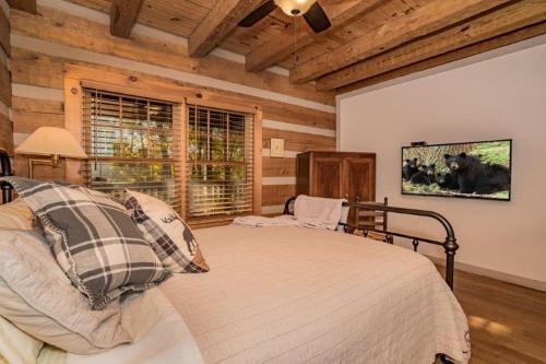 a bedroom with a bed and a tv on a wall at Rockin R Lodge by Eden Crest in Sevierville