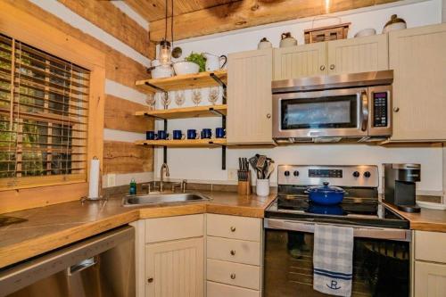 a kitchen with a stove and a microwave at Rockin R Lodge by Eden Crest in Sevierville