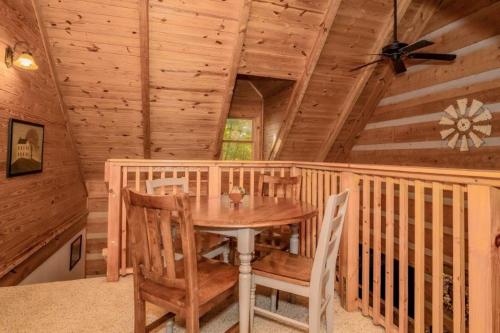 a dining room with a table and chairs in a cabin at Rockin R Lodge by Eden Crest in Sevierville