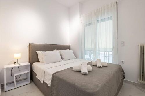 a bedroom with two beds with towels on them at Acropolis Luxury Apartment in Athens