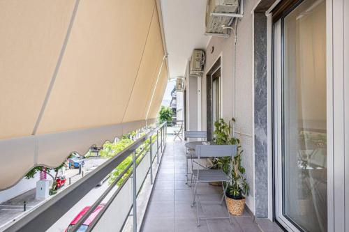 a balcony of a building with chairs and plants at Acropolis Luxury Apartment in Athens