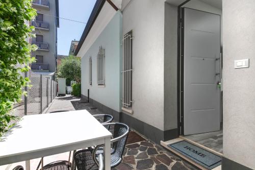 a table and chairs on a balcony with a door at Residence Diffuso Arcobaleno in Gabicce Mare
