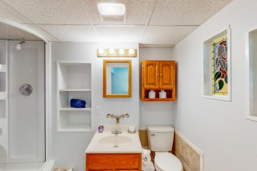 a bathroom with a toilet and a sink at Beechwood Cove in Moneta