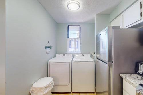 a kitchen with a refrigerator and a washer and dryer at Summer Winds Condo Unit 216 in Indian Beach