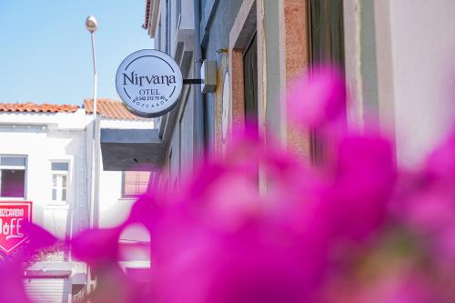 a bunch of pink flowers in front of a building at Nirvana Hotel in Bozcaada