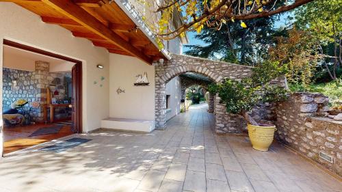 an entrance to a house with a stone wall at Panorama Villa Sea view in Selianitika