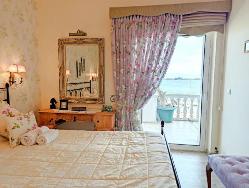 a bedroom with a bed and a mirror and a window at Gavalas Apartment in Agios Konstantinos in Agios Konstantinos Fthiotida