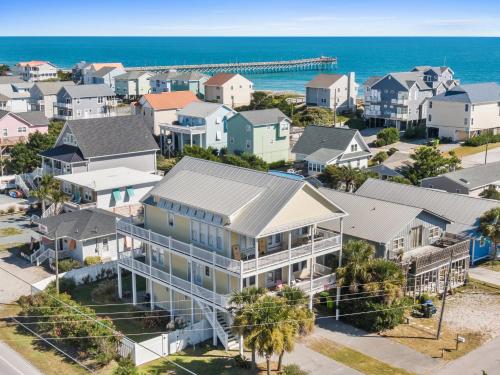 an aerial view of a neighborhood with houses and the ocean at Windansea in Surf City