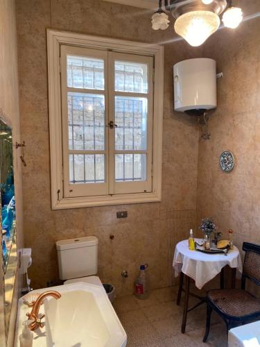 a bathroom with a sink and a window and a table at 10 Downtown in Cairo