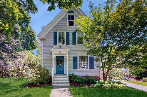 a house with a blue door and trees at Parker House in Camden