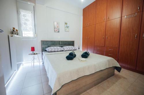 a bedroom with a bed with two bags on it at Dasillion Apartment by Alexia in Igoumenitsa