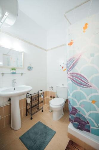 a bathroom with a sink and a toilet at Dasillion Apartment by Alexia in Igoumenitsa