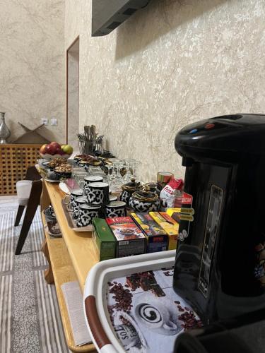 a table in a kitchen with a counter top with books at SAID-MAXSUM in Khiva