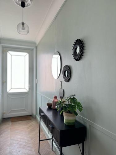 a room with a black table and a mirror at La maison du Maréchal in Parthenay