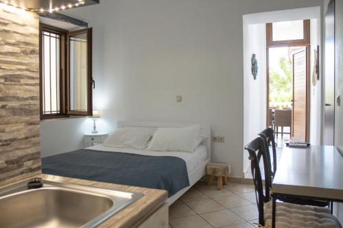 a small bedroom with a bed and a sink at Mamouth Studios in Chania Town