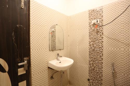 a bathroom with a sink and a mirror at Hotel Grand Kiara Delhi Airport By SS Group in New Delhi
