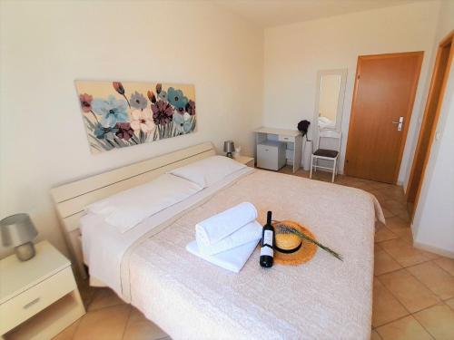 a bedroom with a bed with two towels on it at Rooms Villa Gala in Mlini