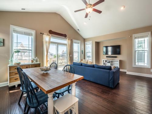 a living room with a blue couch and a table at Sundancer in Surf City