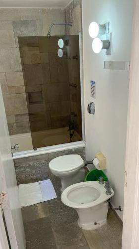a bathroom with a toilet and a shower at Pousada Pé na Areia Guarujá in Guarujá