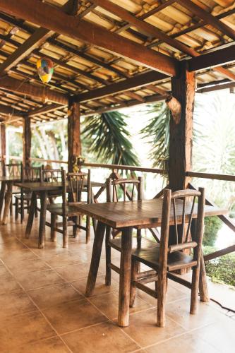 a row of wooden tables and chairs in a pavilion at Pousada Luar in Santana do Riacho
