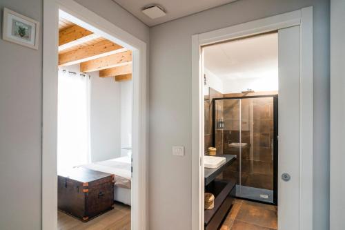 a bathroom with a shower and a sink and a mirror at Casa Riberi Mole Antonelliana Centro in Turin
