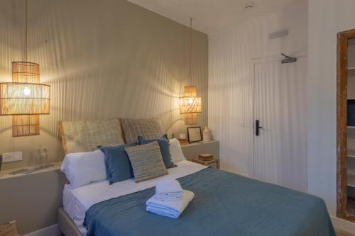 a bedroom with a bed with two towels on it at Hostal Boutique Sa Nansa in Tossa de Mar