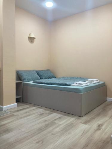 a bedroom with a bed with blue sheets on it at Best Value Apartment in Tbilisi Center in Tbilisi City