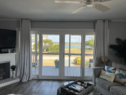 a living room with a couch and a sliding glass door at Unforgettable Memories in Surf City