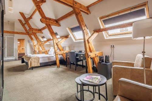 a bedroom with a bed and a desk in a room at Grand Hotel Alkmaar in Alkmaar