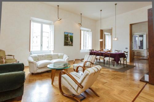 sala de estar con muebles blancos y mesa en Habitat's Navona 4BR Apartment, en Roma