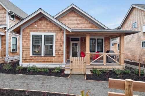 a house with a porch with a fence at Salt and Vine Cottage by Seabrook Hospitality in Pacific Beach