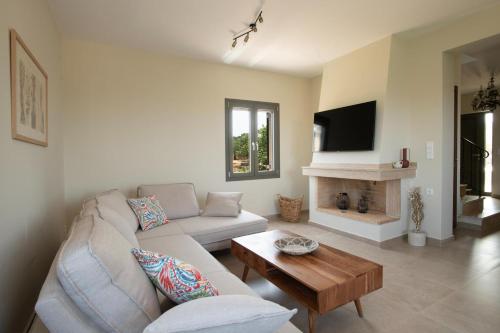 a living room with a couch and a table at Modone Villas in Peloponnese in Methoni