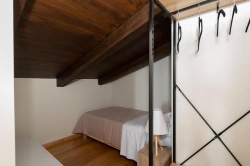 a bedroom with a bed and a wooden ceiling at Modone Villas in Peloponnese in Methoni